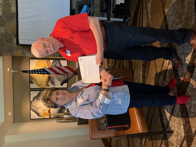 Gail Joyce receiving a certificate of appreciation